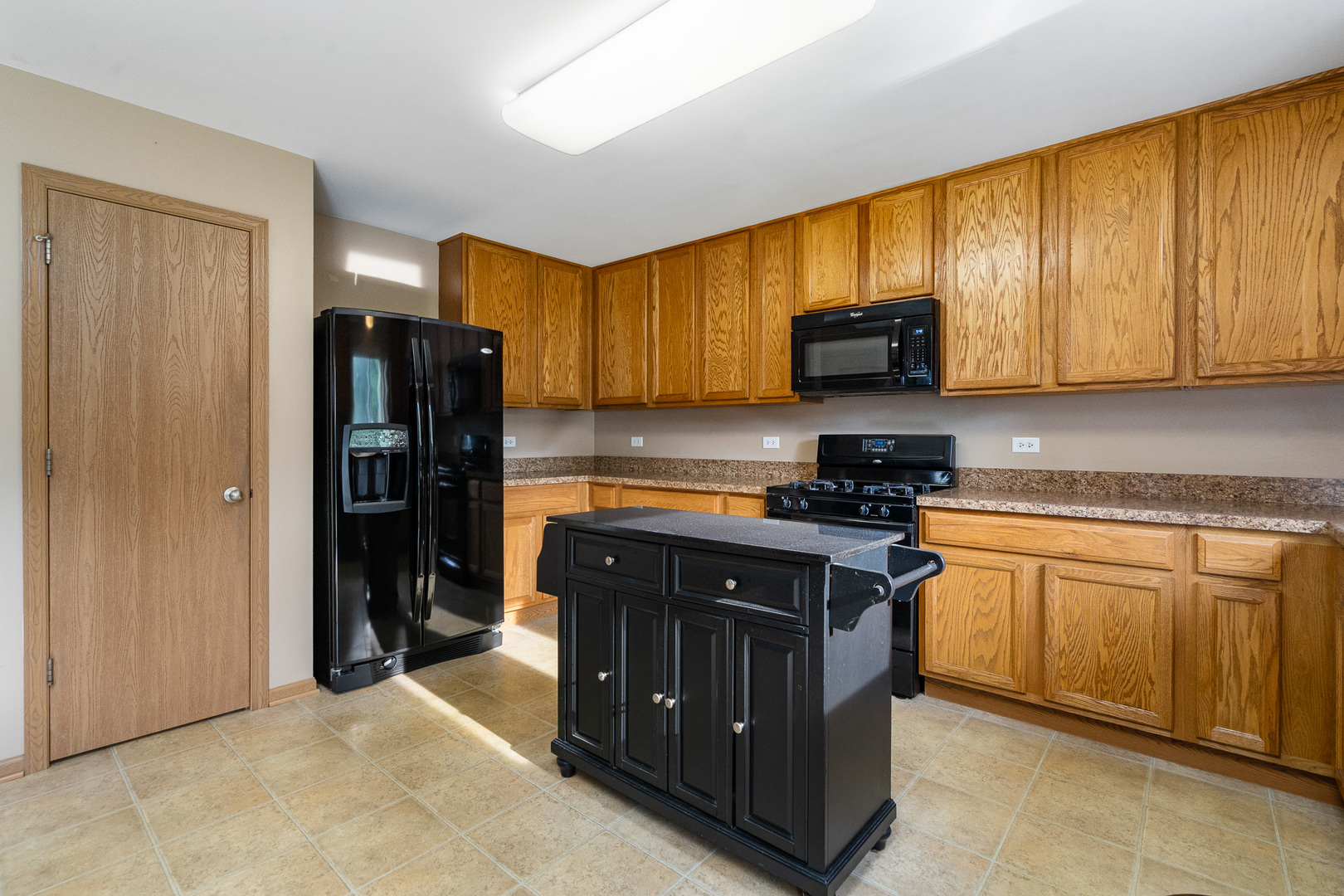 16320 Spring Creek Lane Plainfield, IL 60586 - Photo 9 of 40 a kitchen with stainless steel appliances granite countertop a stove a refrigerator and a sink