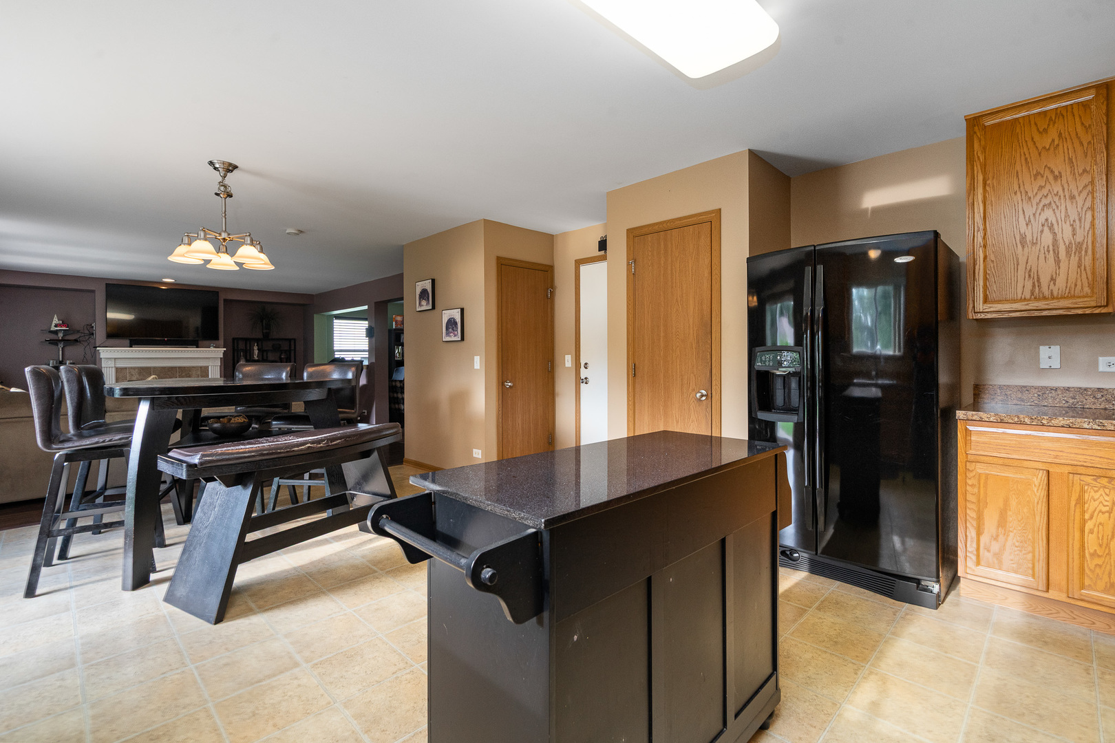 16320 Spring Creek Lane Plainfield, IL 60586 - Photo 10 of 40 a kitchen with stainless steel appliances kitchen island granite countertop a refrigerator and a stove top oven