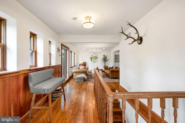 a very nice looking room with many windows and furniture