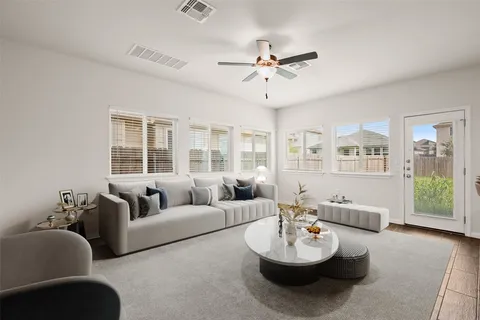 a living room with furniture and a large window