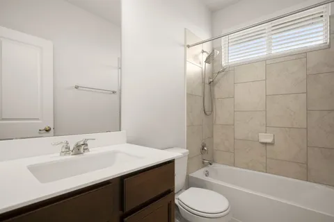 a bathroom with a sink a toilet and a bathtub
