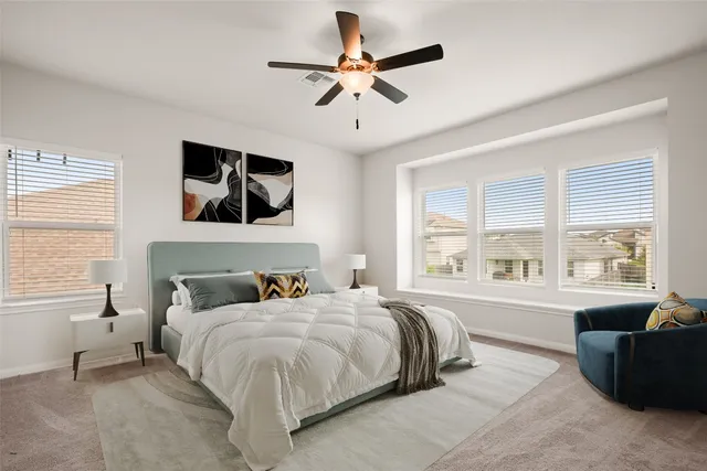 a bedroom with a large bed and a window