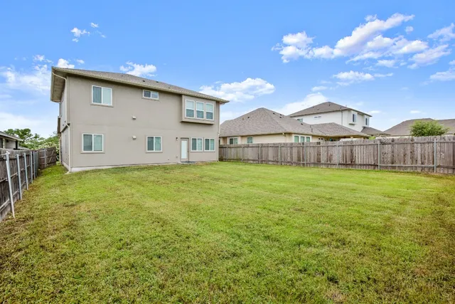 a view of a house with a backyard