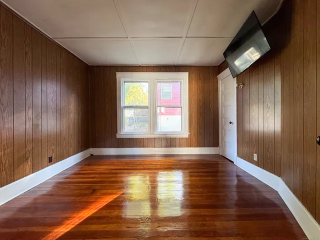 a view of a kitchen with refrigerator and white cabinets