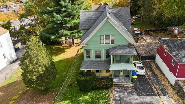 an aerial view of a house with a yard