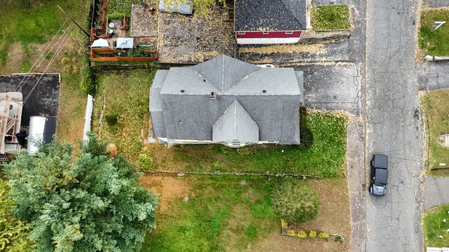 a front view of a house with yard and green space