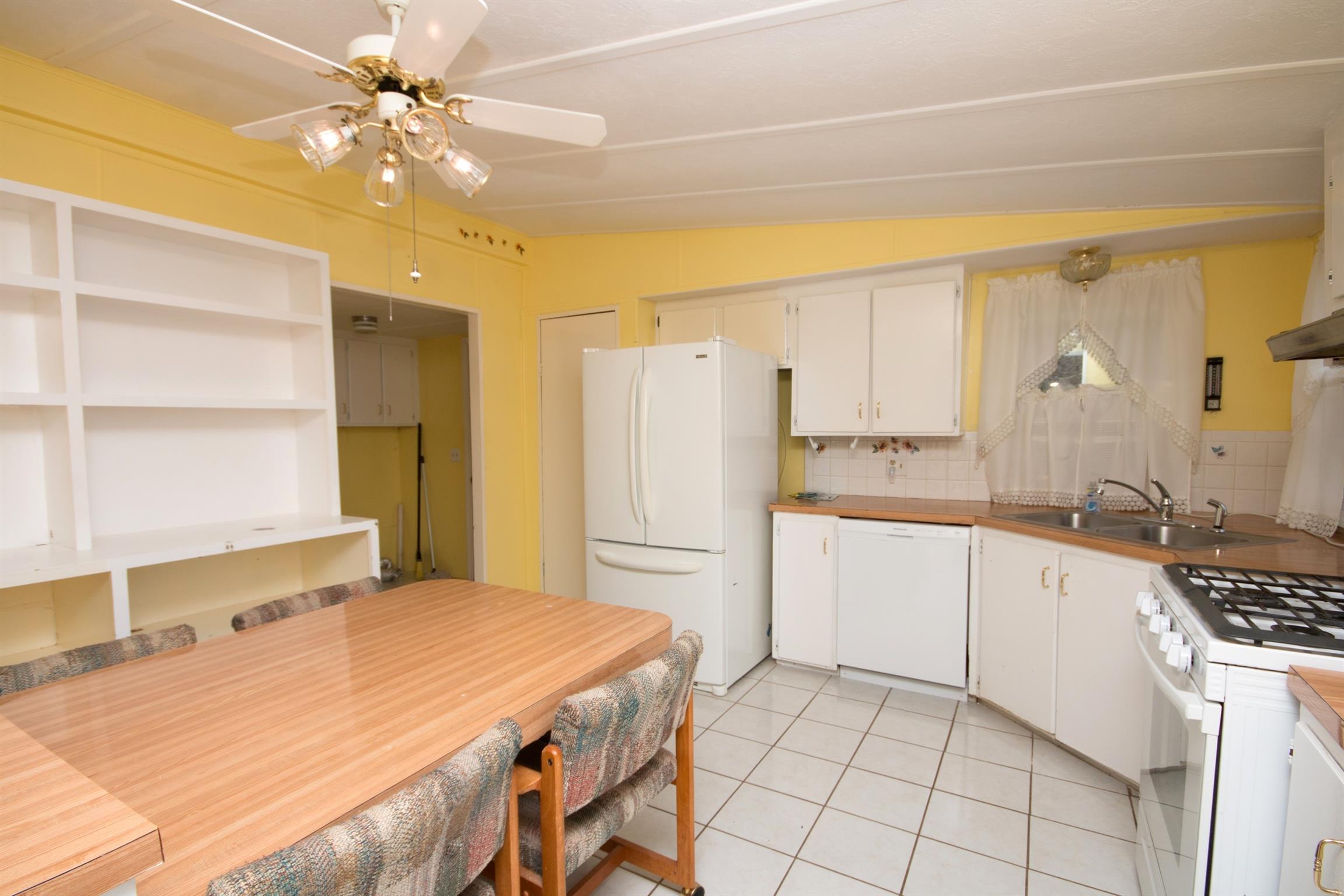 149 Mitchell Road Portland, TN 37148 - Photo 17 of 29 a kitchen with a table chairs and a refrigerator