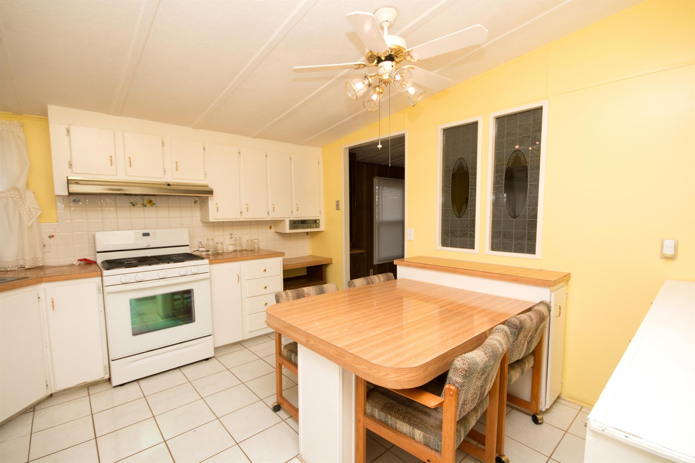 149 Mitchell Road Portland, TN 37148 - Photo 18 of 29 a kitchen with a stove a sink and a refrigerator