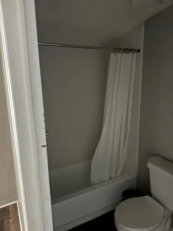 a bathroom with a toilet and a shower