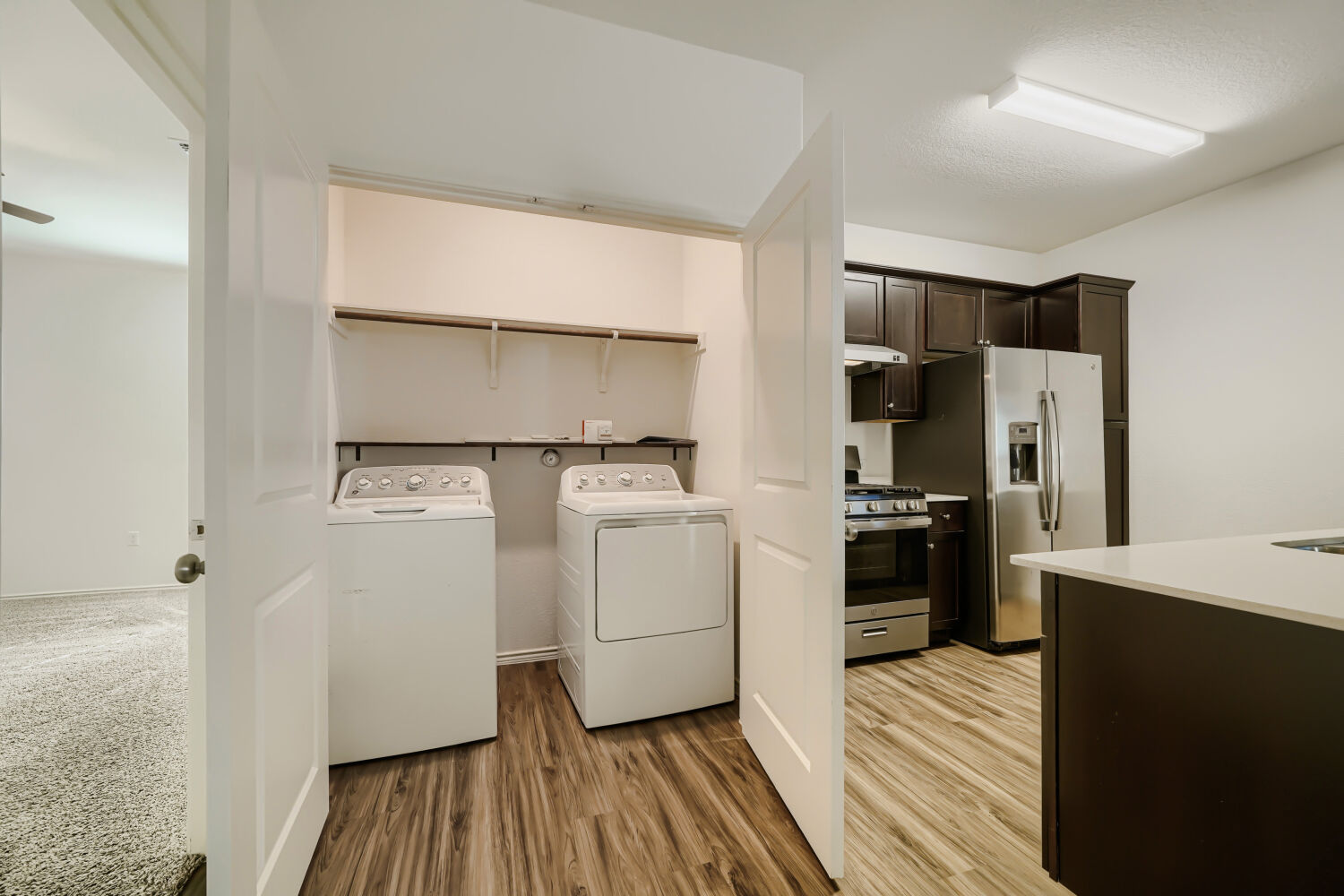 7001 Tonka Lane Austin, TX 78744 - Photo 24 of 30 a kitchen with a refrigerator and white cabinets