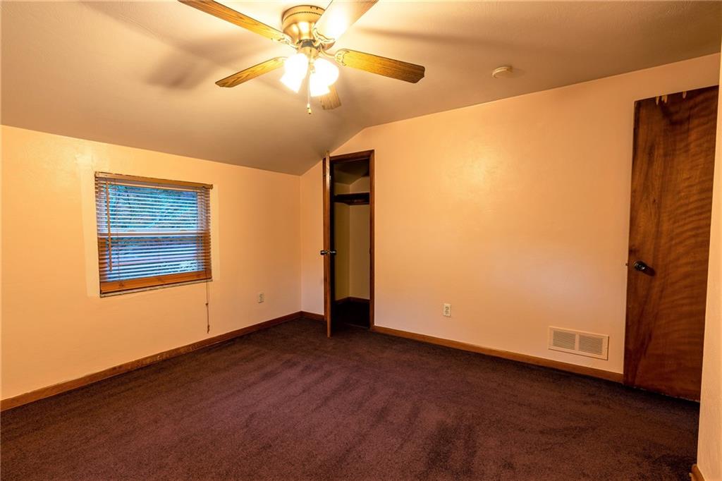 586 Filmore Road Pittsburgh, PA 15221 - Photo 18 of 25 an empty room with a ceiling fan and a window