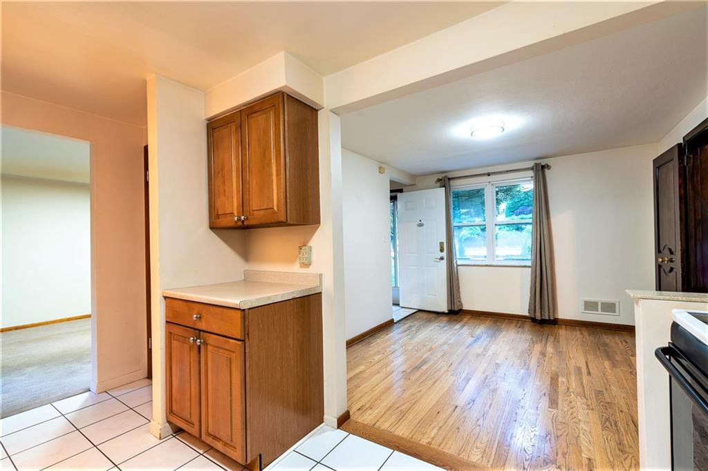 586 Filmore Road Pittsburgh, PA 15221 - Photo 9 of 25 a view of kitchen with wooden floor and electronic appliances