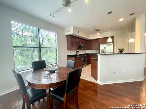a view of a dining room with furniture and wooden floor