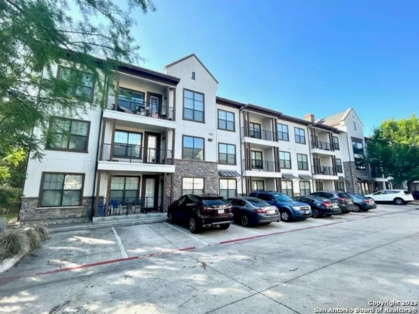 a buildings with car parked in front of it