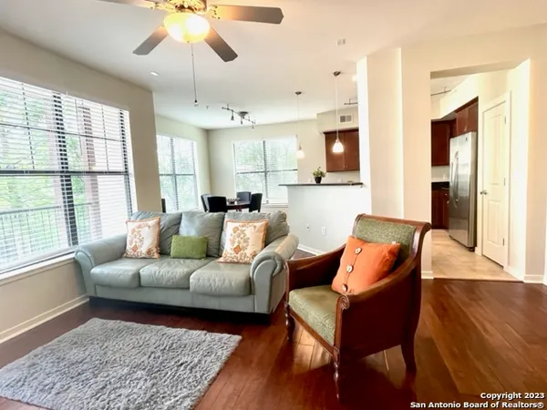 a living room with furniture and wooden floor