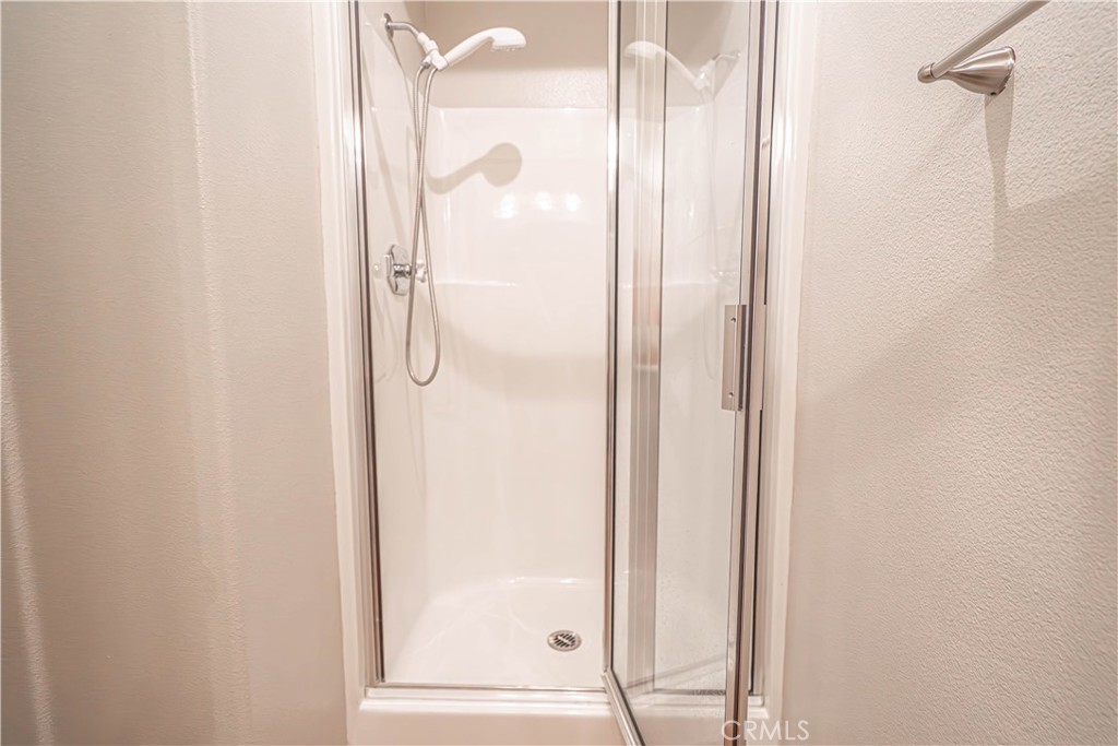 28772 Woodside Drive Saugus, CA 91390 - Photo 14 of 23 a bathroom with a glass shower door
