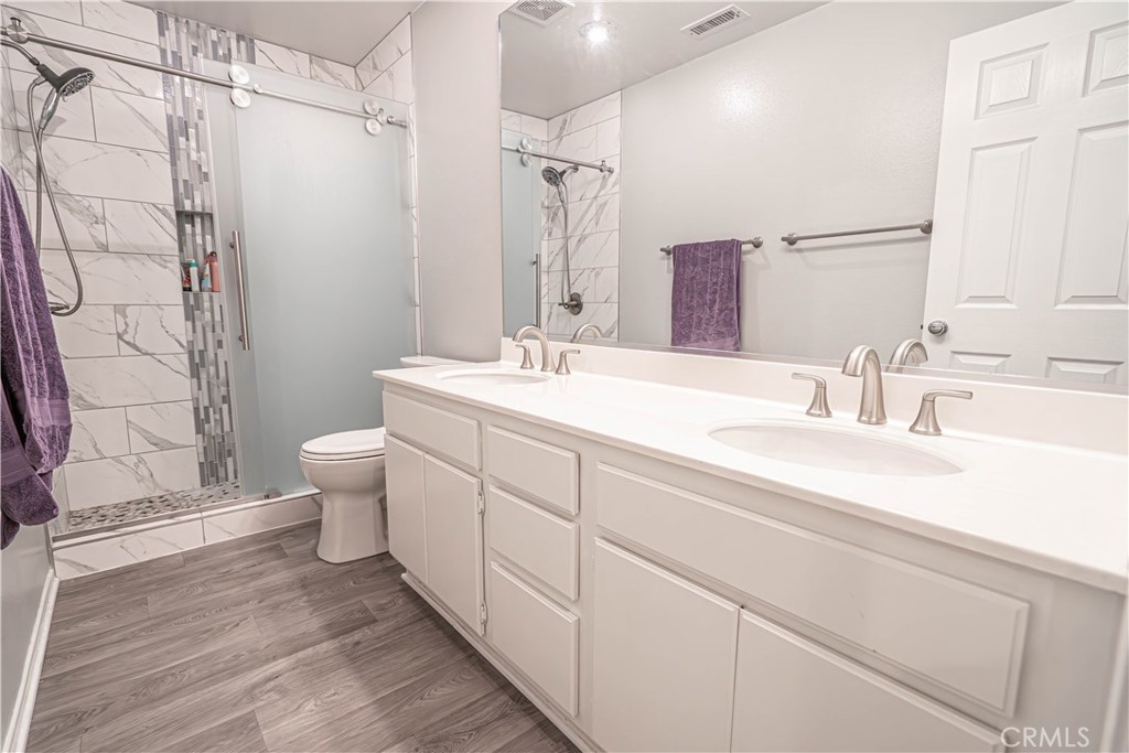 28772 Woodside Drive Saugus, CA 91390 - Photo 18 of 23 a bathroom with a double vanity sink toilet and shower