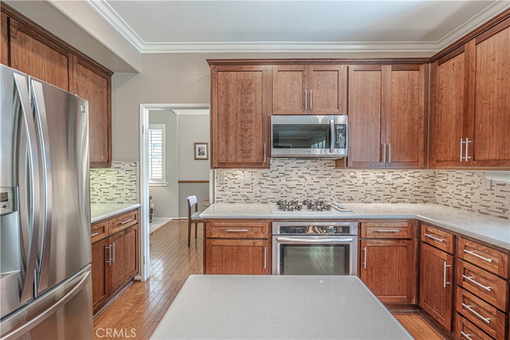 28772 Woodside Drive Saugus, CA 91390 - Photo 9 of 23 a kitchen with stainless steel appliances granite countertop a refrigerator stove and sink