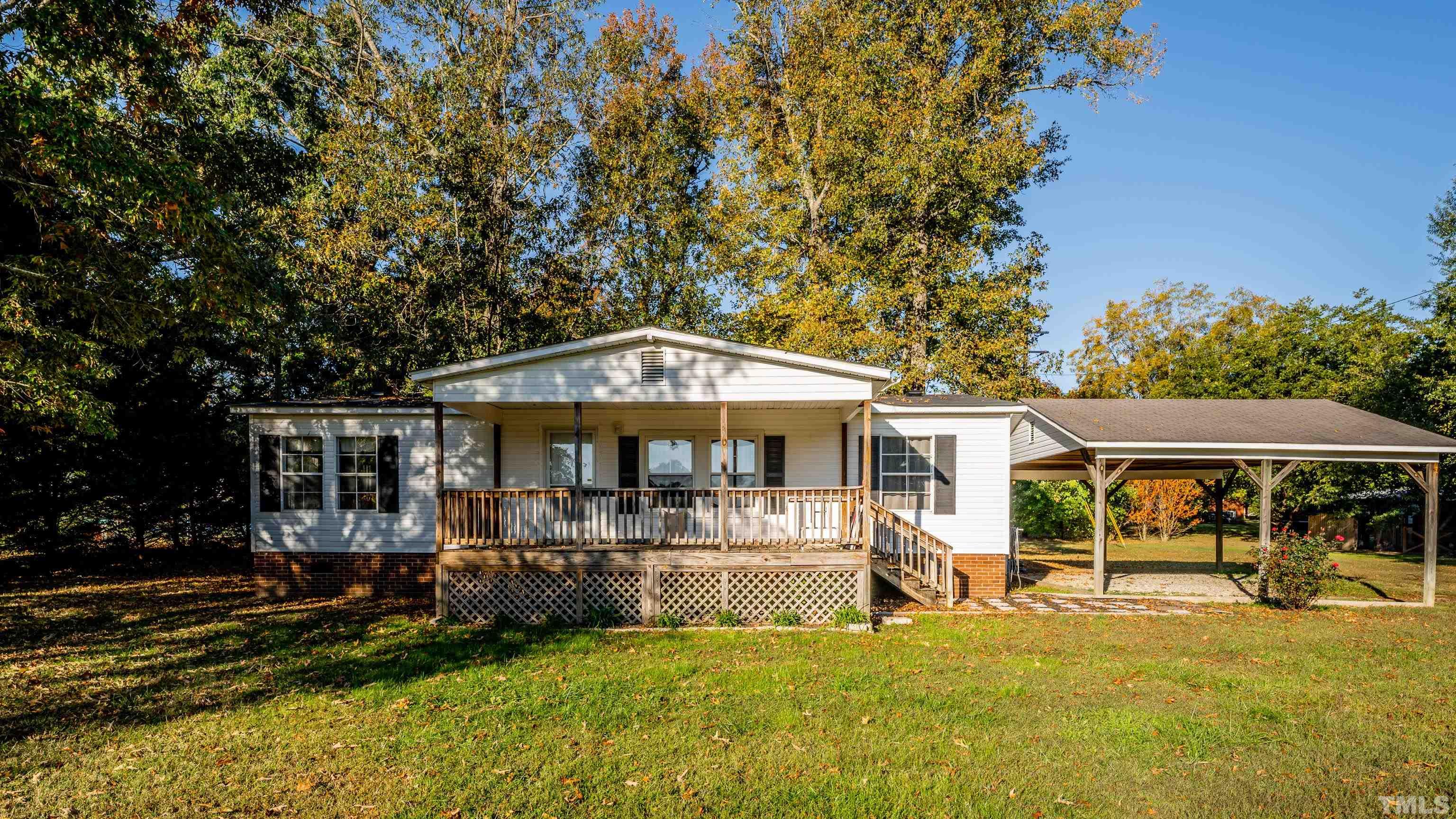200 David Lane Roxboro, NC 27573 - Photo 1 of 38 a front view of a house with a yard table and chairs