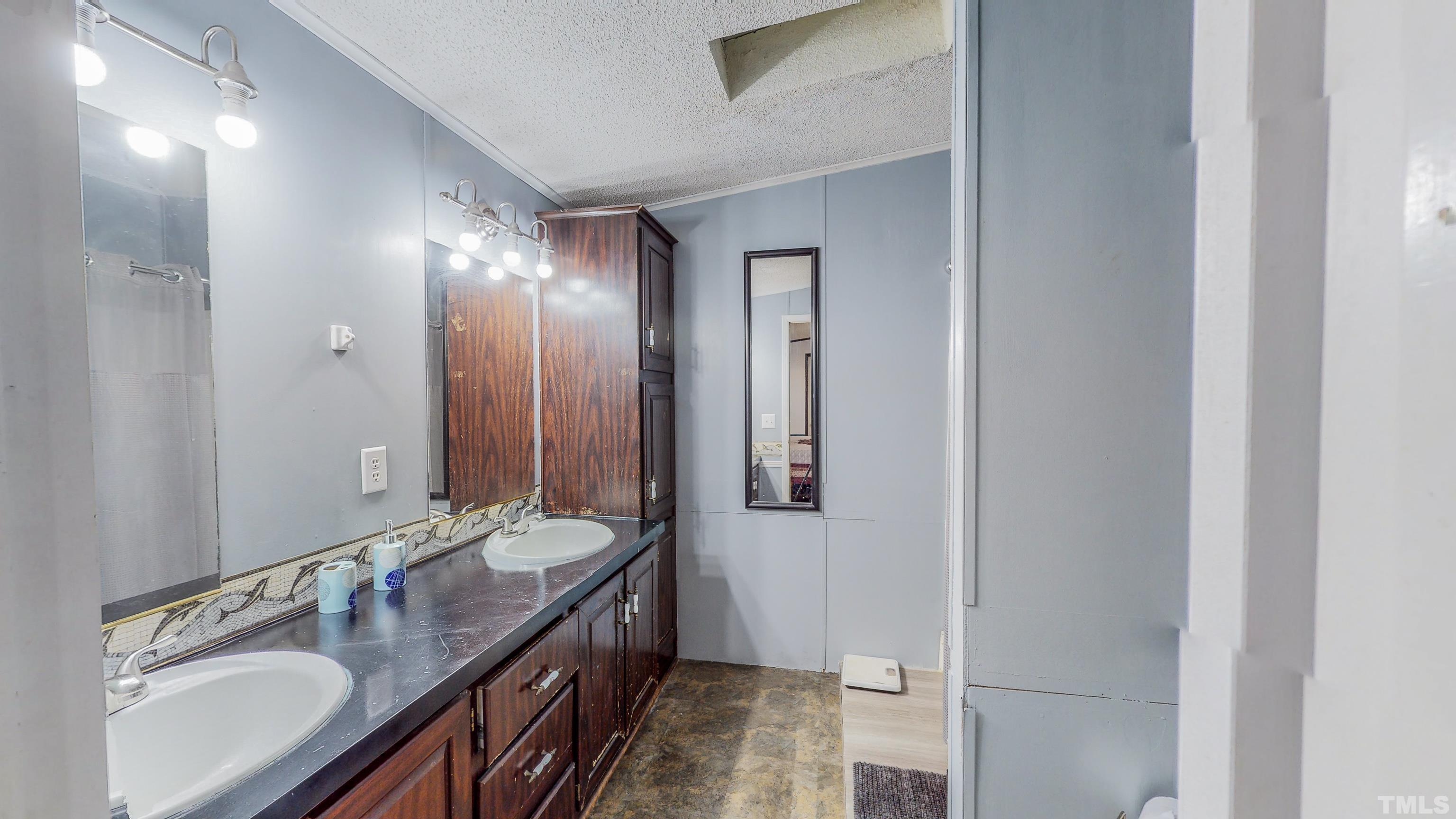 200 David Lane Roxboro, NC 27573 - Photo 16 of 38 a spacious bathroom with a double vanity sink and a mirror