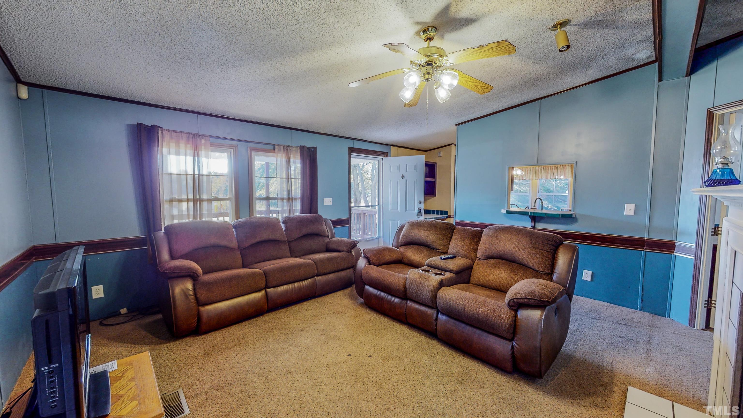 200 David Lane Roxboro, NC 27573 - Photo 23 of 38 a living room with furniture and a chandelier