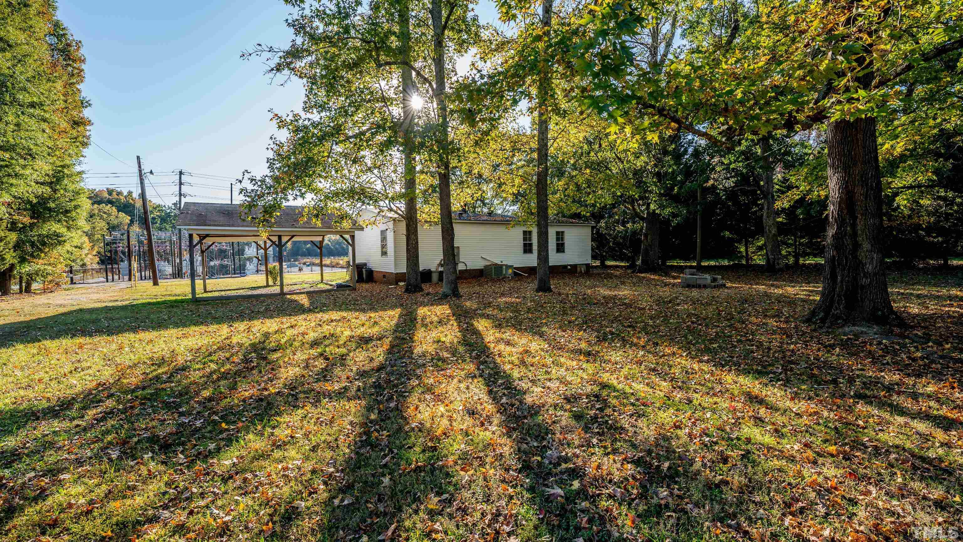200 David Lane Roxboro, NC 27573 - Photo 7 of 38 a backyard of a house with lots of green space and fountain