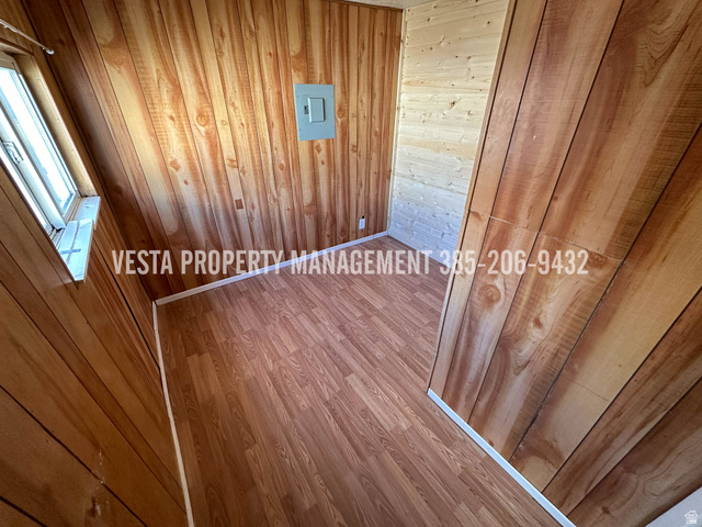 471 East 22nd Street Ogden, UT 84401 - Photo 8 of 12 Unfurnished room featuring wood walls and wood finished floors