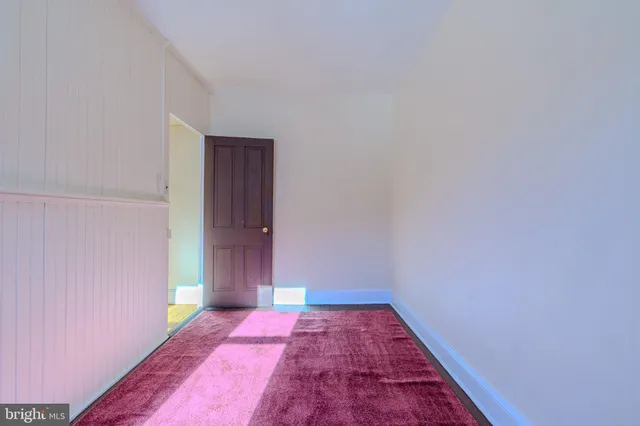 a view of hallway with wooden floor