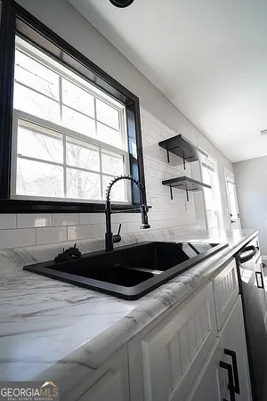 a metallic refrigerator freezer sitting in a kitchen