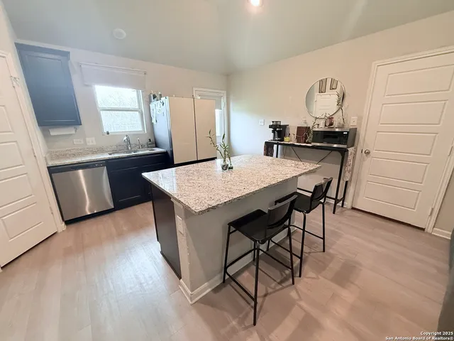 a view of kitchen island with granite countertop furniture