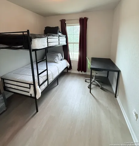 a bedroom with a bed a desk and chair