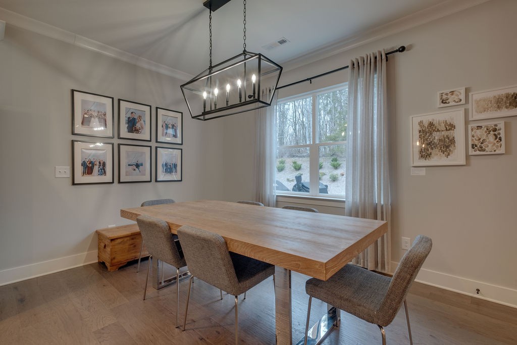 713 Plowson Road Mount Juliet, TN 37122 - Photo 11 of 33 a view of a dining room with furniture window and wooden floor