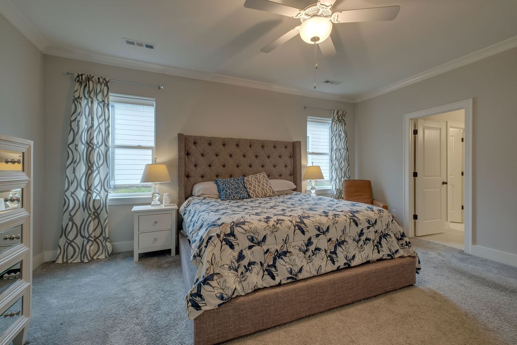 713 Plowson Road Mount Juliet, TN 37122 - Photo 18 of 33 a bedroom with a bed and a chandelier
