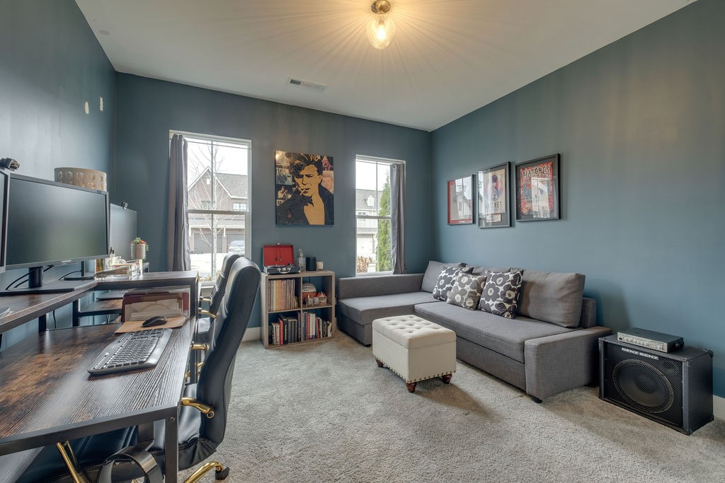 713 Plowson Road Mount Juliet, TN 37122 - Photo 27 of 33 a living room with furniture and a flat screen tv