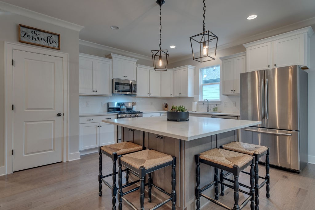 713 Plowson Road Mount Juliet, TN 37122 - Photo 7 of 33 a kitchen with refrigerator cabinets and wooden floor