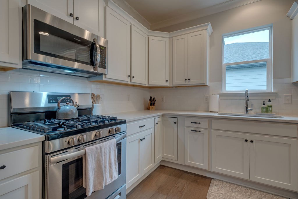 713 Plowson Road Mount Juliet, TN 37122 - Photo 8 of 33 a kitchen with stainless steel appliances granite countertop white cabinets a sink and dishwasher