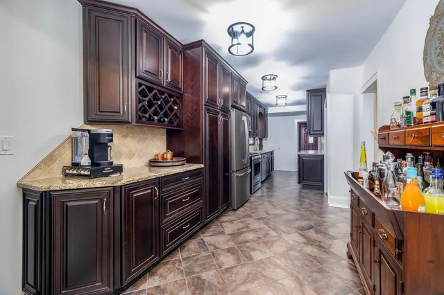 a kitchen with refrigerator and window