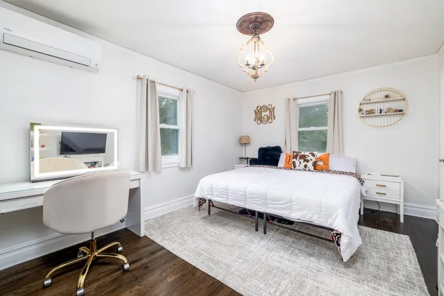 a bed room with a bed and a chandelier