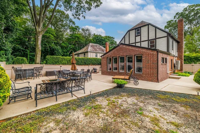 a view of a house with backyard porch and sitting area