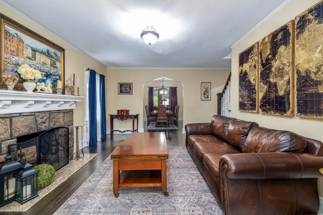 a living room with furniture a fireplace and a large window