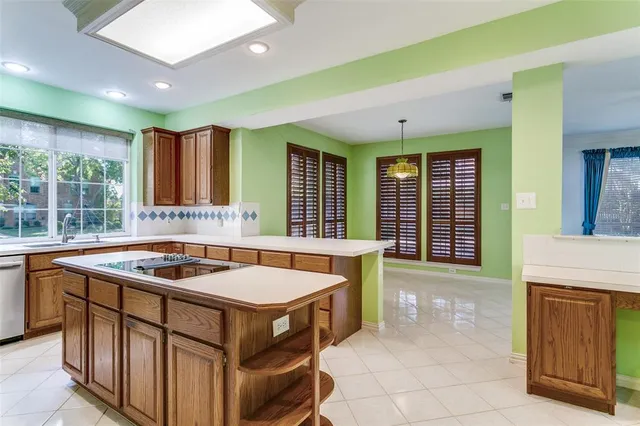 a kitchen that has a sink and a stove in it
