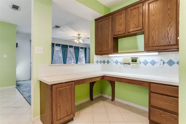 a kitchen with a sink cabinets and wooden floor