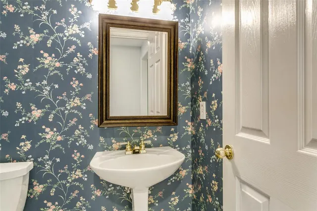 a bathroom with a sink a toilet and mirror