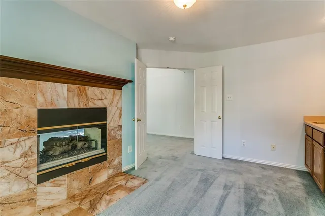 a view of empty room with a fireplace