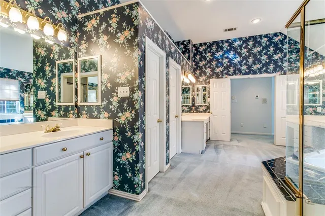 a bathroom with a tub sink and mirror