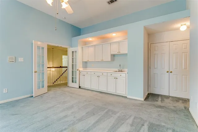 a view of a kitchen with a sink and a refrigerator