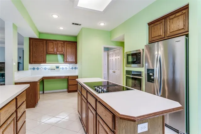a kitchen with stainless steel appliances granite countertop a sink refrigerator and stove