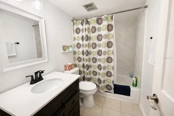 a bedroom with a bed and a table chair