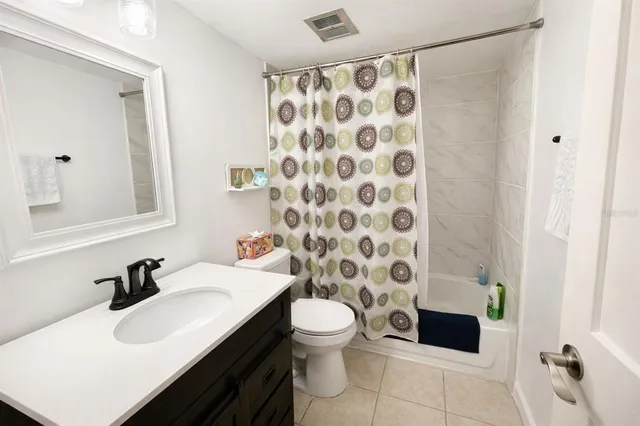 a bedroom with a bed and a table chair