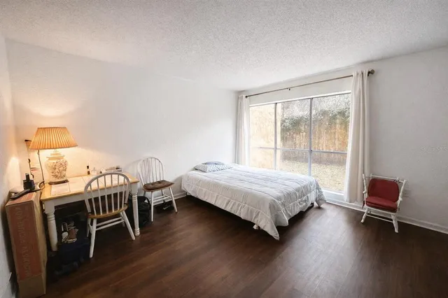 a bedroom with a bed and a chair